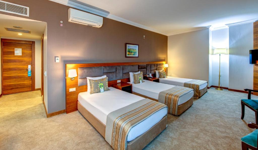 A bed or beds in a room at Bera Konya Hotel