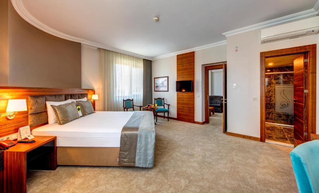 A bed or beds in a room at Bera Konya Hotel