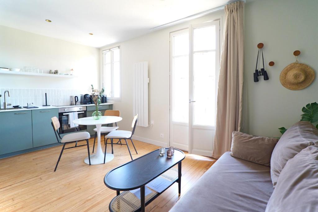 - un salon avec un canapé et une table dans l'établissement Villa Adèle, Sauna et Balcon vue Mer - Appt 03, à Mers-les-Bains