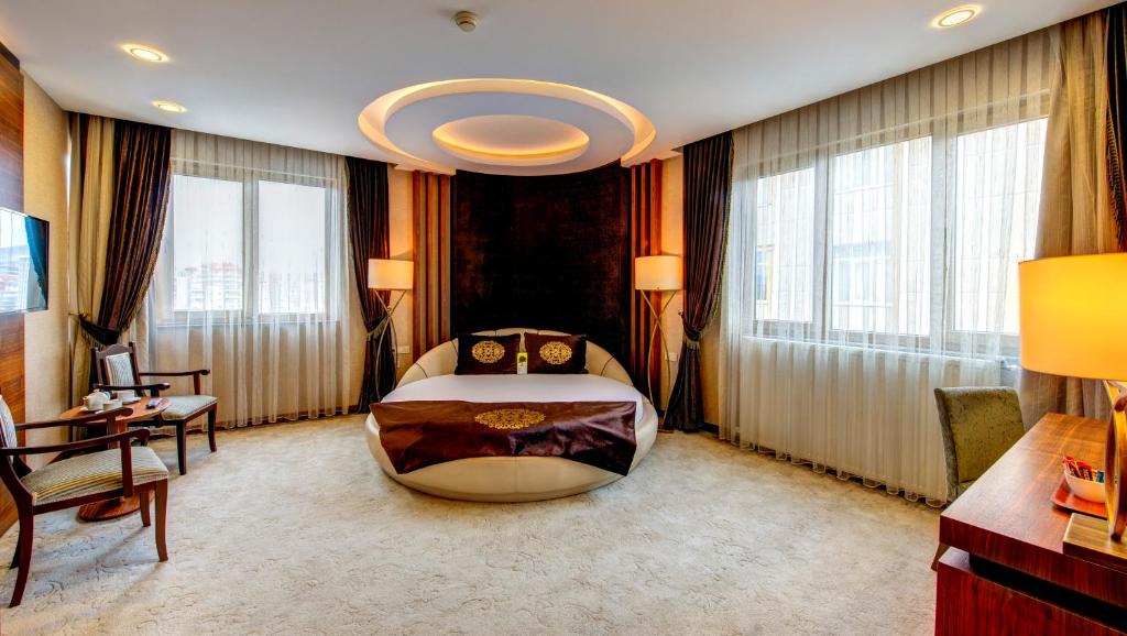 A bed or beds in a room at Bera Konya Hotel