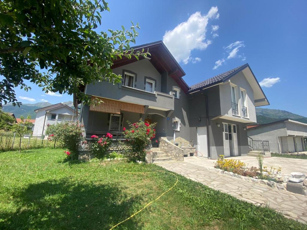 a house with a lawn in front of it at Guesthouse GS 84326 in Gusinje