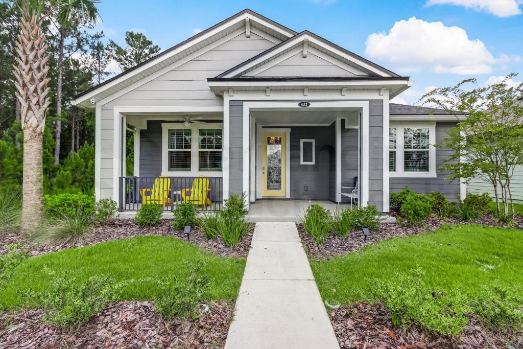 a home with a gray house with yellow doors at 632 Palmetto Place - Wildlight home in Yulee