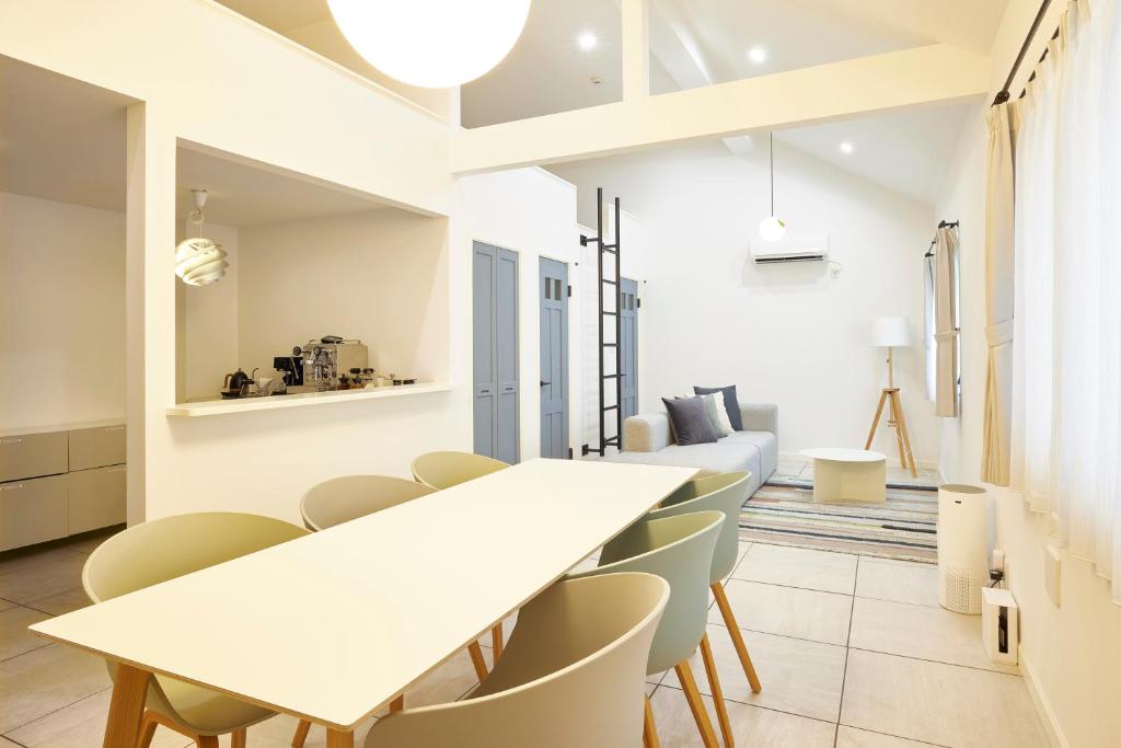 a dining room with white tables and chairs at COFFEE HOTEL Soundwave in Fujisawa