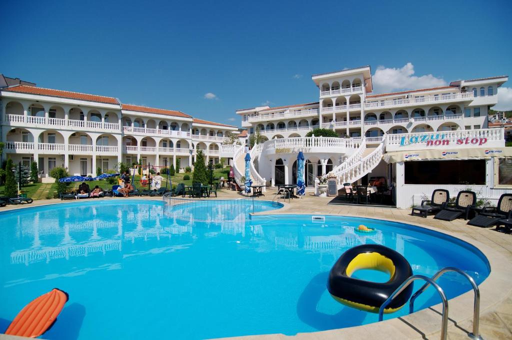 a large swimming pool in front of a large building at LAZUR 1, 2, 3, 4, 5 Apart Complex in Sveti Vlas