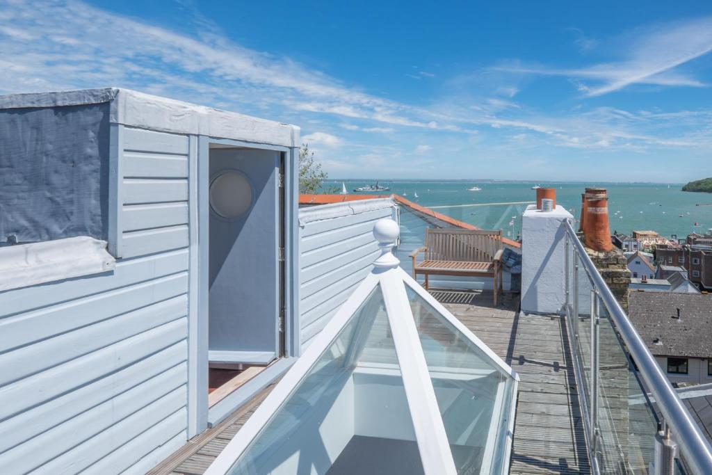 a balcony of a house with a view of the water at Cliffhanger 18 Castle Road in Cowes