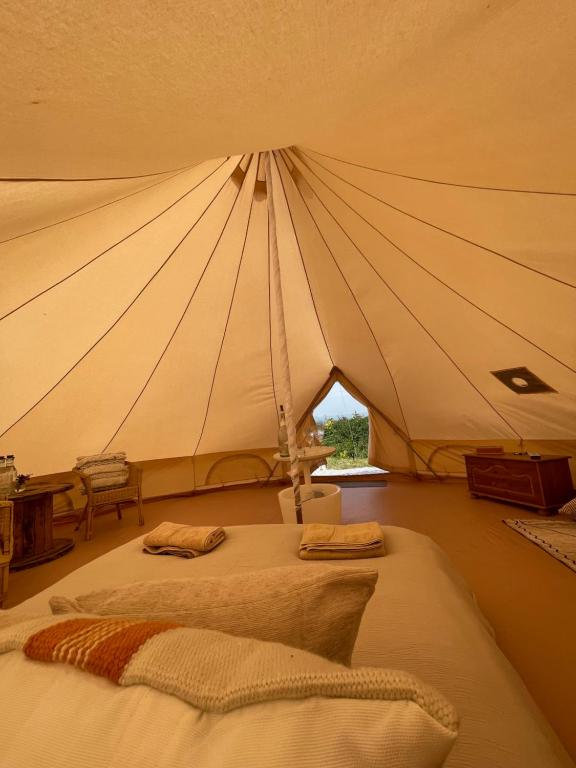 a bedroom with two beds in a tent at Wheeldon Escapes in Totnes