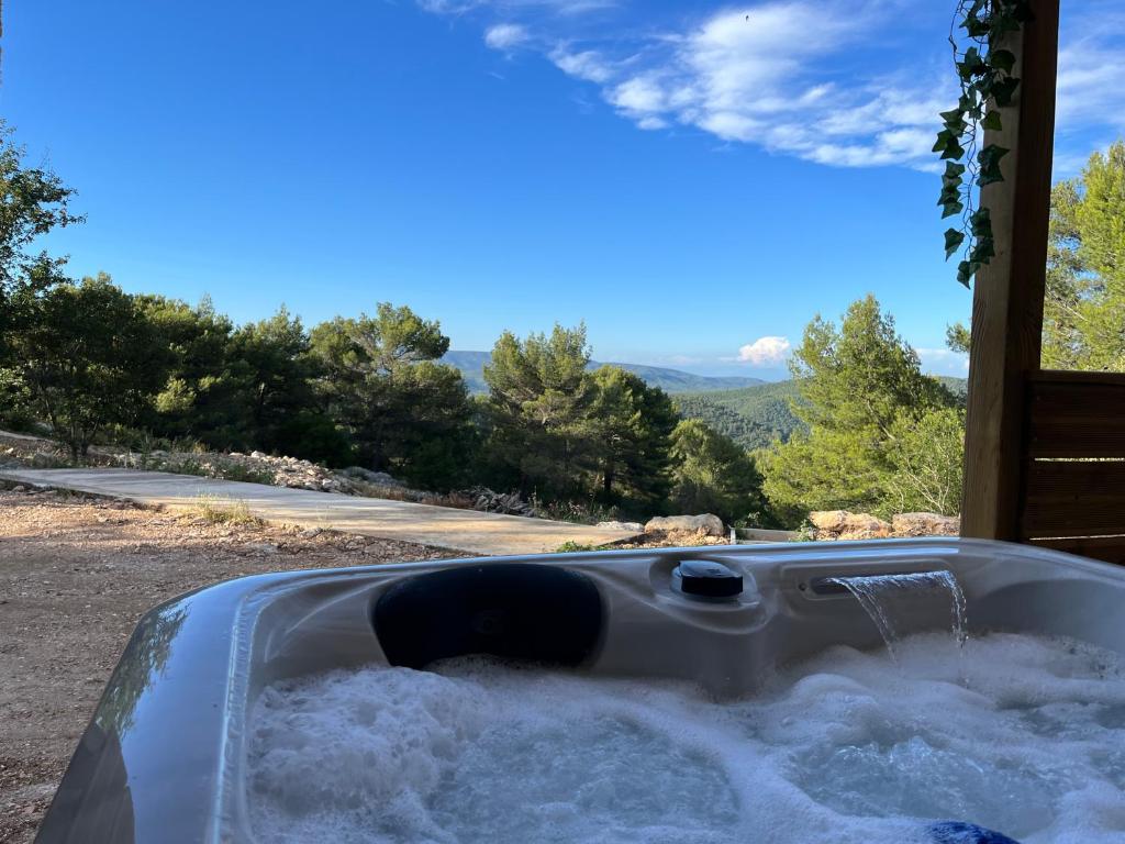 a bath tub filled with water in a yard at Le Maquis Rooms in Plan dʼAups