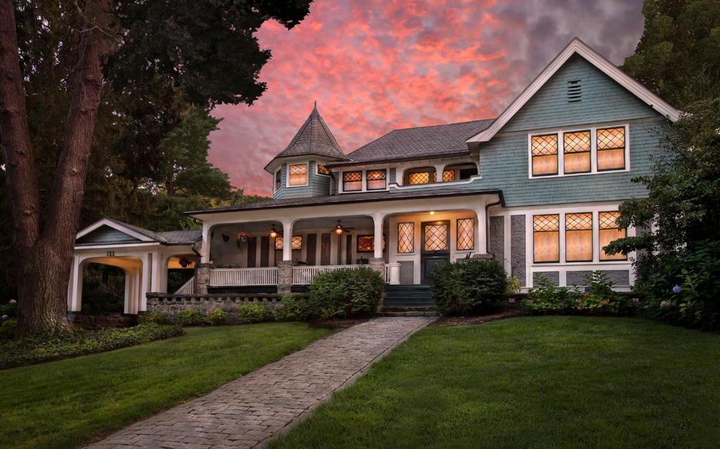 a large house with a sunset in the background at Black Walnut B&B Inn in Asheville