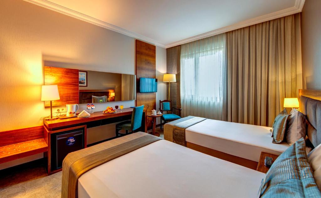 A bed or beds in a room at Bera Konya Hotel