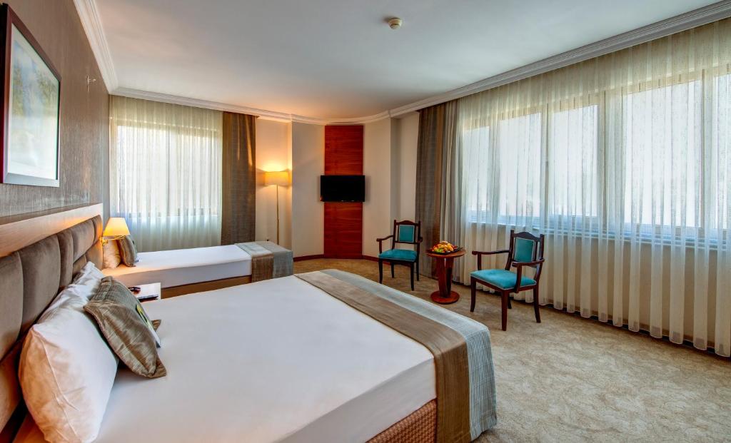 A bed or beds in a room at Bera Konya Hotel