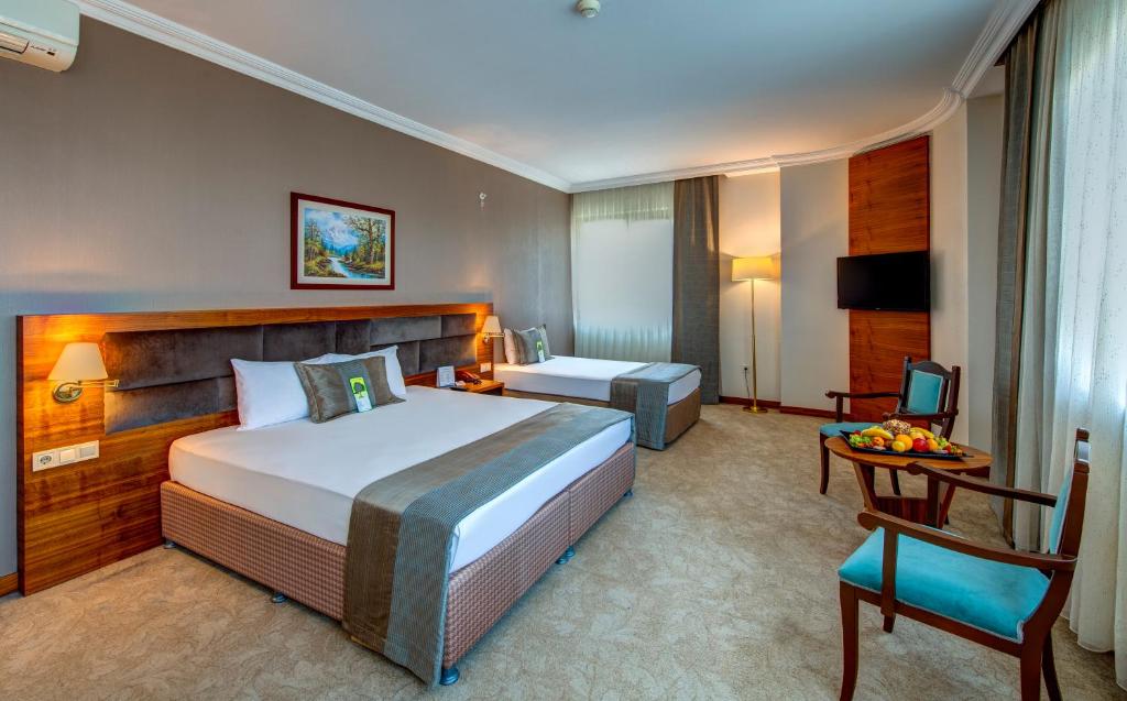 A bed or beds in a room at Bera Konya Hotel