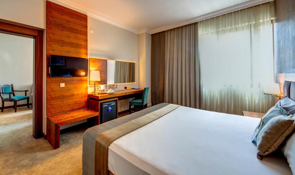 A bed or beds in a room at Bera Konya Hotel