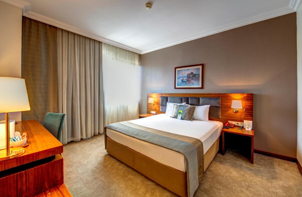 A bed or beds in a room at Bera Konya Hotel