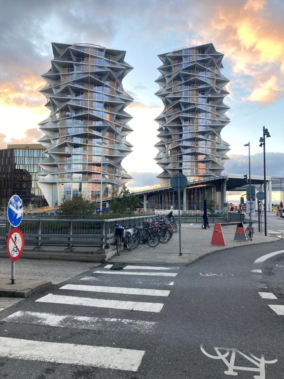 two tall glass buildings on a city street at The View in Copenhagen