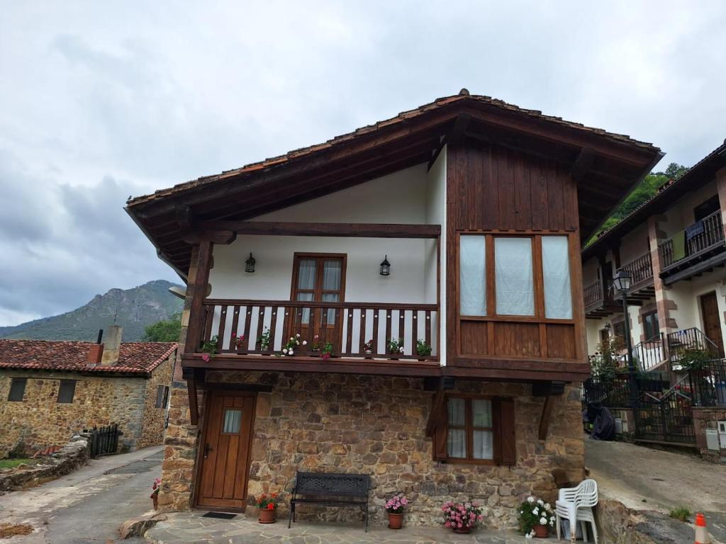 a small house with a balcony on top of it at La casa de Omi in Camaleño