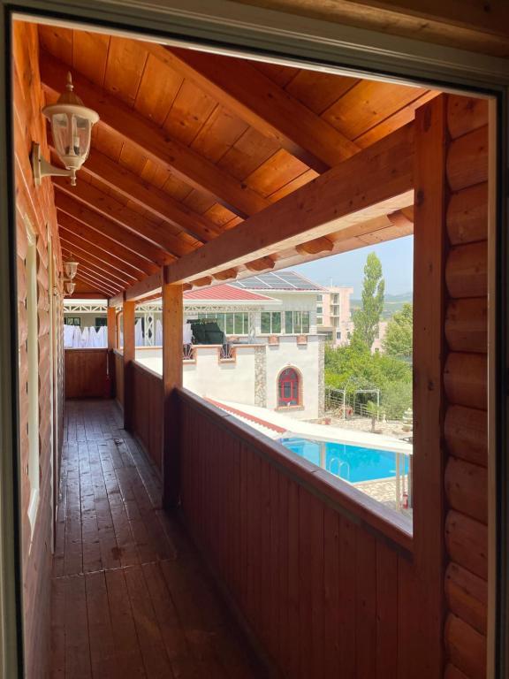 a porch with a view of a swimming pool at Vila Livio - Guest house Rreshen Mirdite in Rrëshen