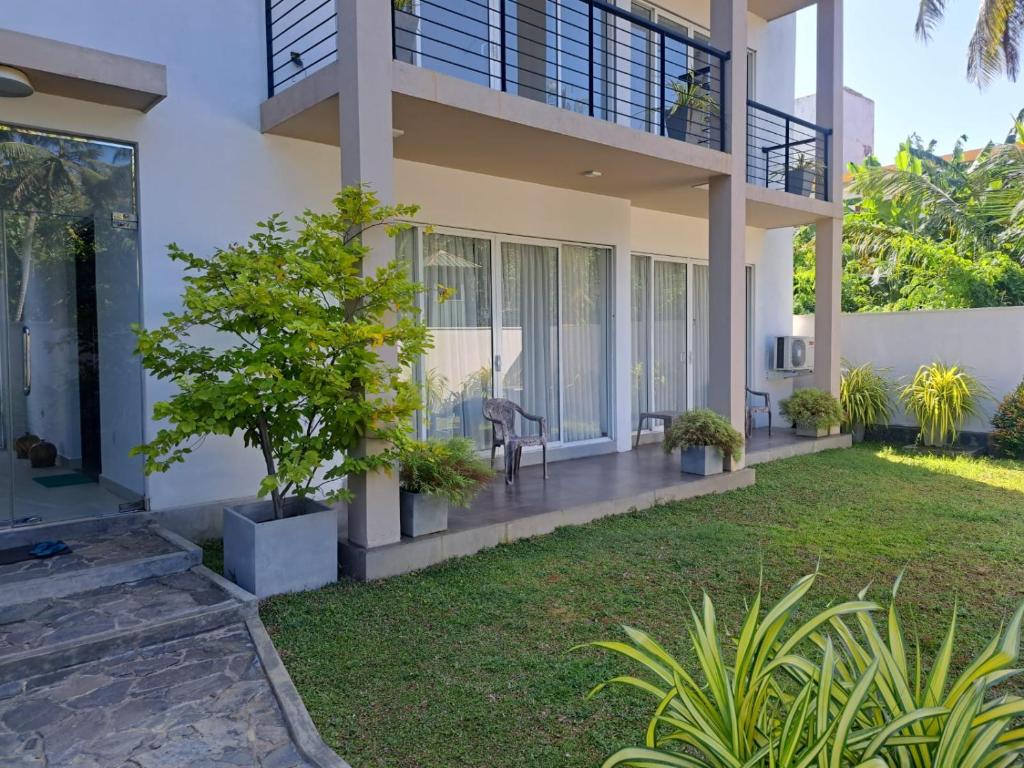 a house with a lawn in front of it at Silina Airport Residence in Katunayake