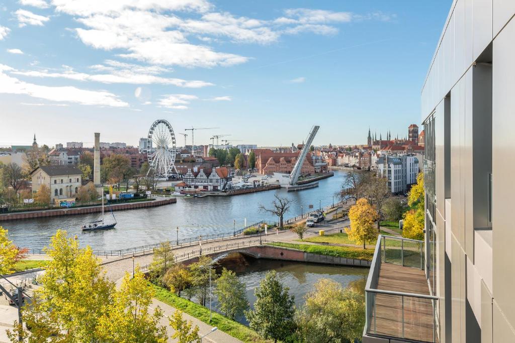 a view of a river from a building at Blue Mandarin Riverside Premium Sauna & Gym in Gdańsk
