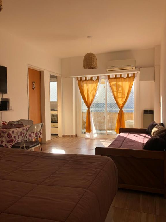 a bedroom with a bed and a view of the ocean at Departamento En Flores Av Avellaneda, Nazca Excelente Ubicación En Centro Comercial in Buenos Aires
