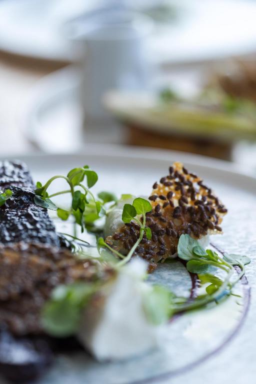 a plate of food with plants on it at Fistral Beach Hotel and Spa - Adults Only in Newquay