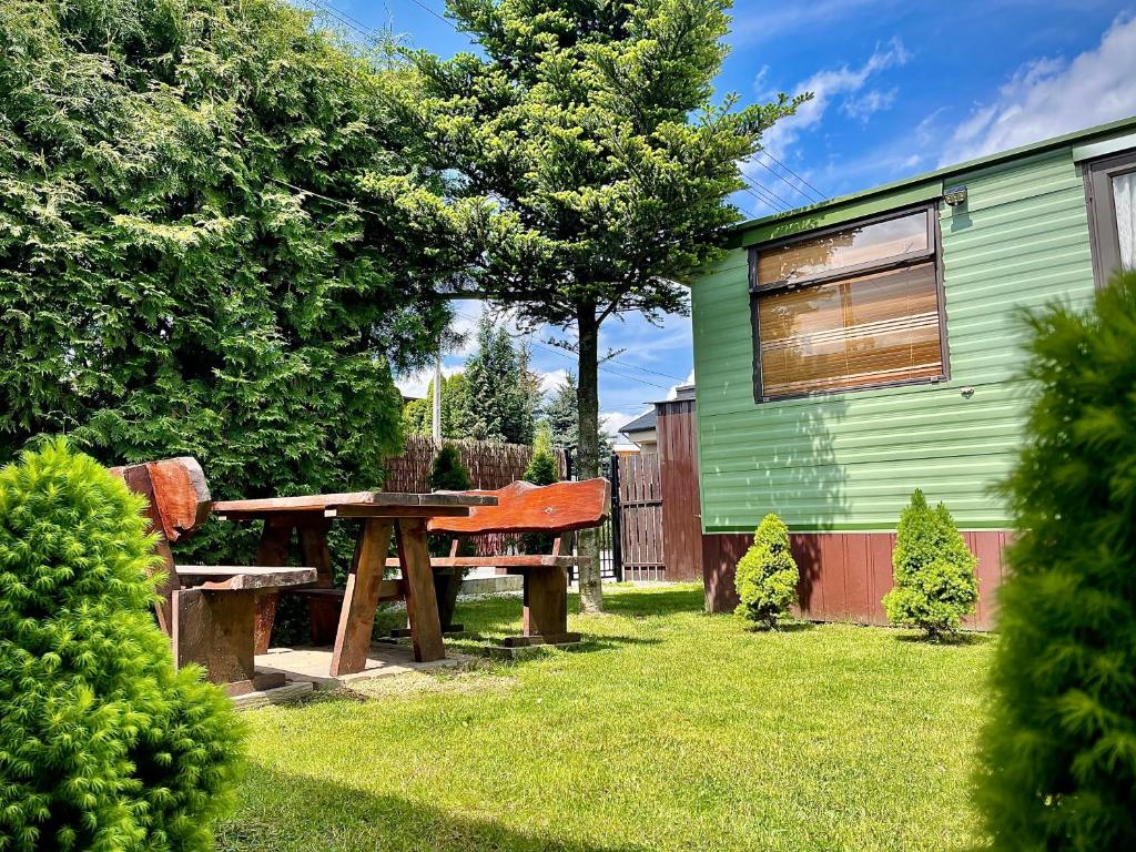 a picnic table and bench in the yard of a house at Riviera Zator in Zator