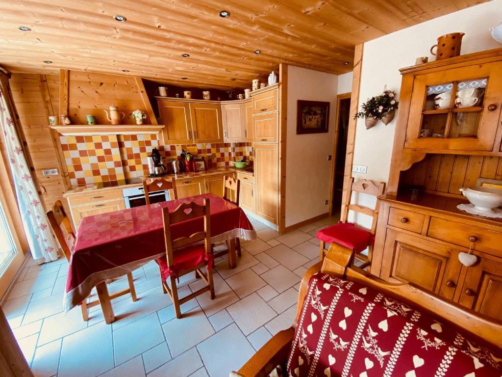 a kitchen with a table and chairs in a room at Appartement La Clusaz, 3 pièces, 5 personnes - FR-1-459-68 in La Clusaz