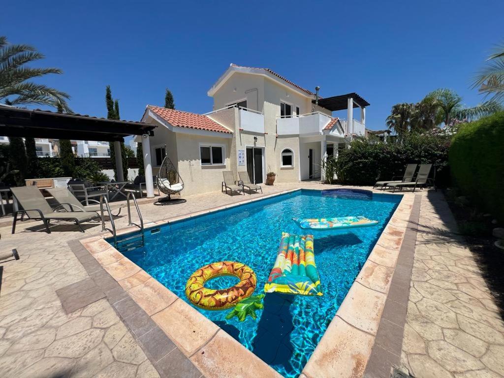 a swimming pool in front of a house at Villa Tamara with Private Pool in Peyia