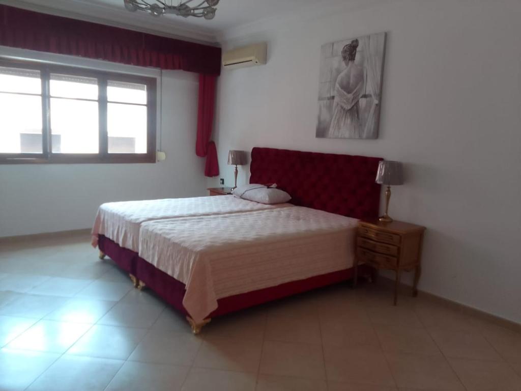 a bedroom with a large bed and a window at إقامة الصداقة in Larache