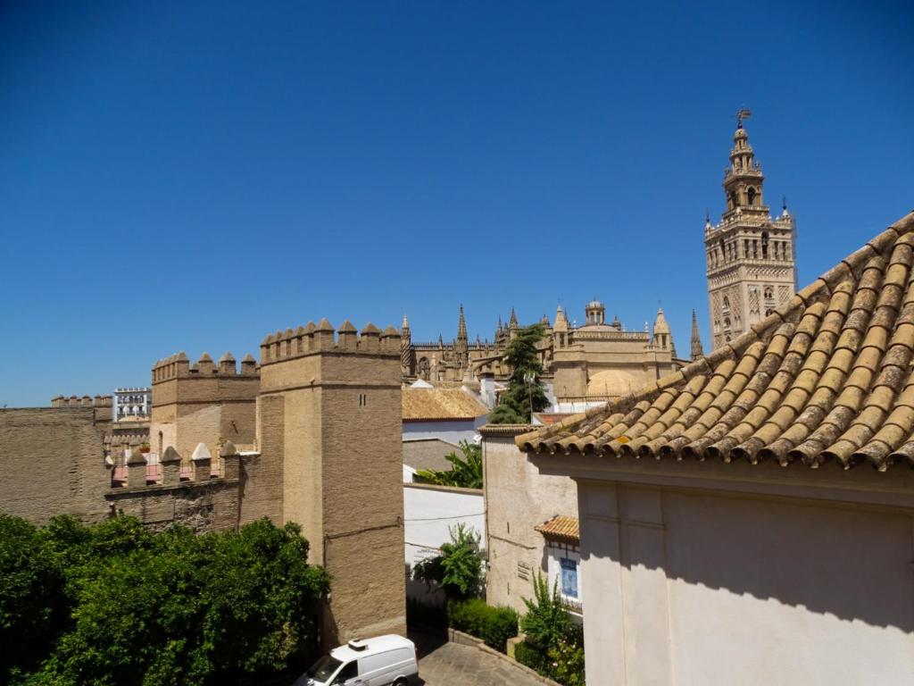 a view of a building with a clock tower at Apartamento con vistas a la Giralda. in Seville