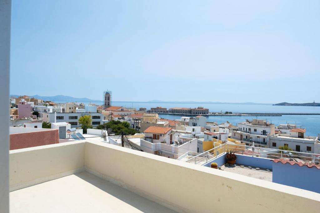 a view of the city from a balcony at House 8 in Ermoupoli