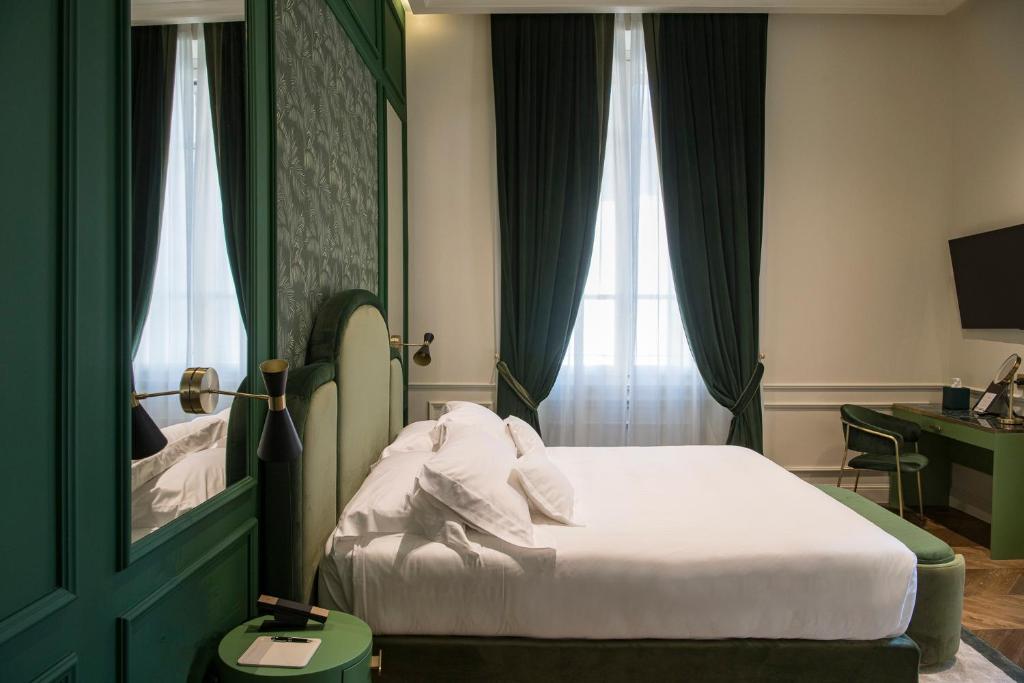 A bed or beds in a room at Hotel La Gemma