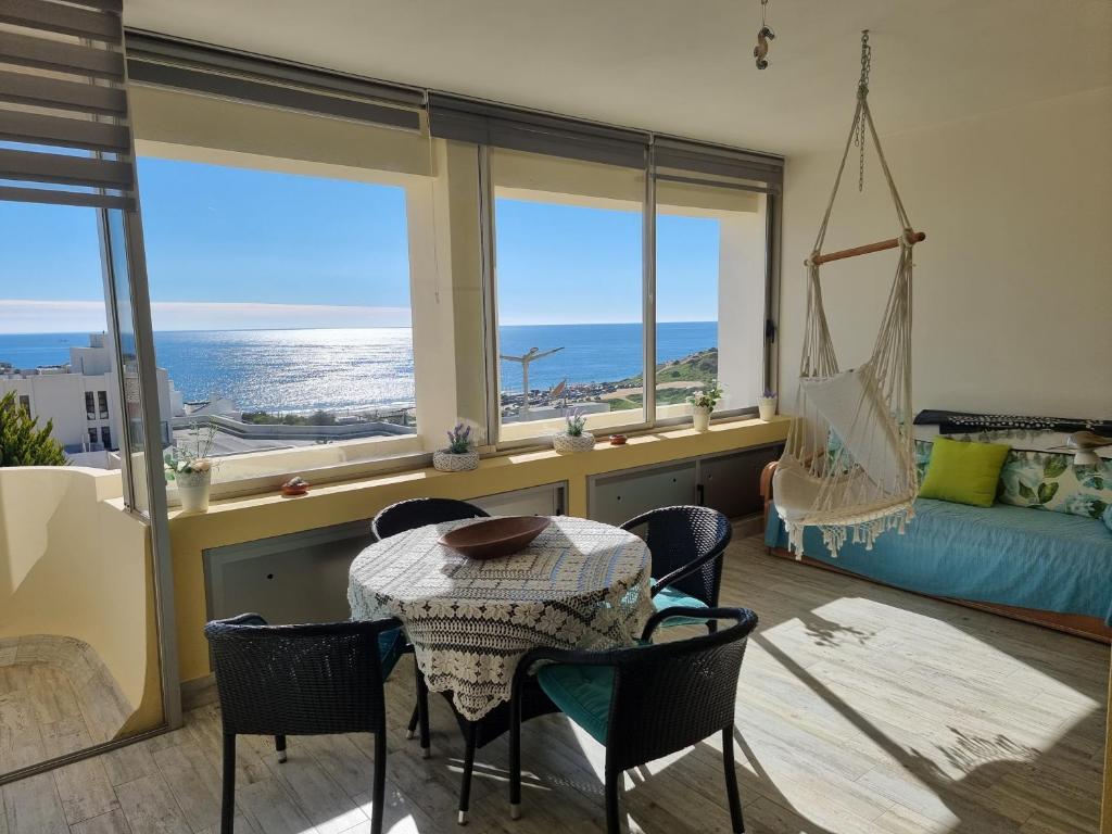 a living room with a table and chairs and a bedroom at SALTY SANDY in Lagos