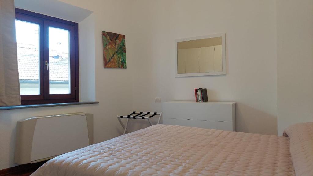 Habitación blanca con cama y ventana en Casa Vacanze I Leoni Empoli, en Empoli