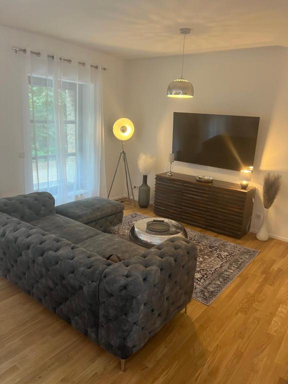a living room with a couch and a flat screen tv at Luxuswohnung Nähe Köln Bonn in Troisdorf