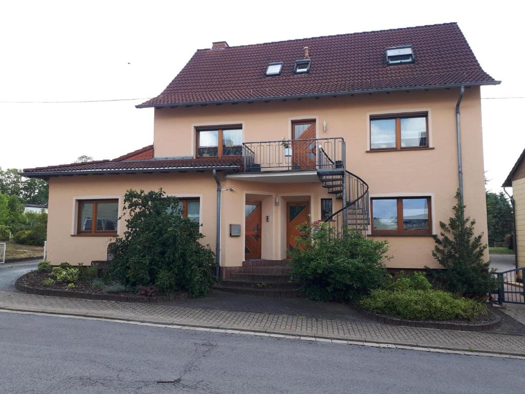 aige house with a balcony on a street at Ferienwohnung Müller in Wadern