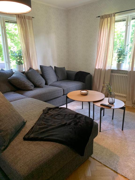 a living room with a couch and a table at Lägenhet på Strömsholm in Jönköping