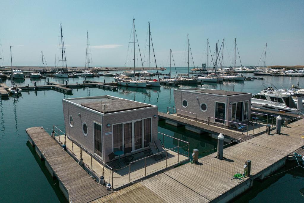a dock with boats in a marina with boats at Marina del Gargano Houseboat in Manfredonia