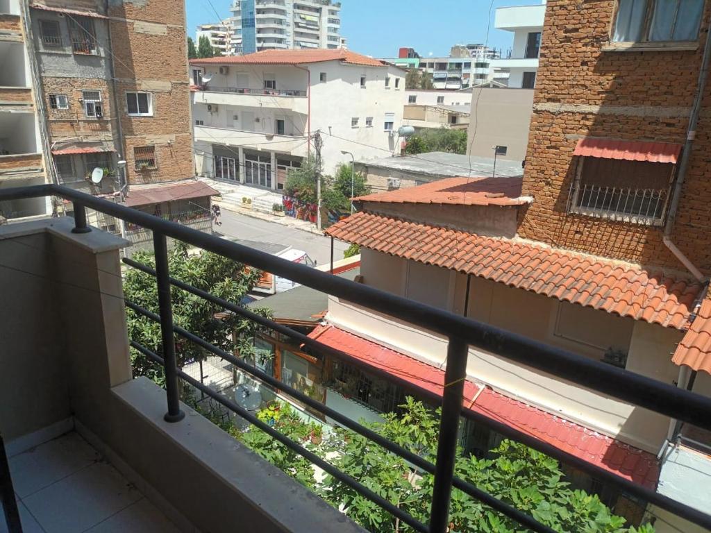a balcony with a view of a street and buildings at Ridi Apartament's in Vlorë