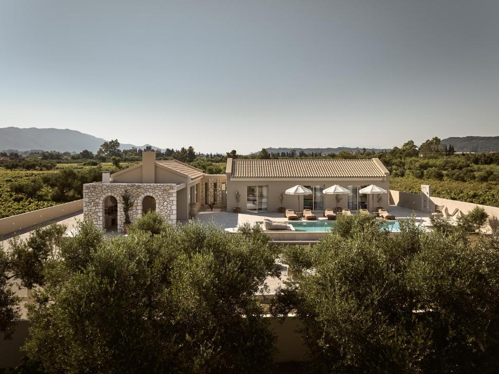 an aerial view of a villa with a swimming pool at Uvetta Villa in Makhairádhon