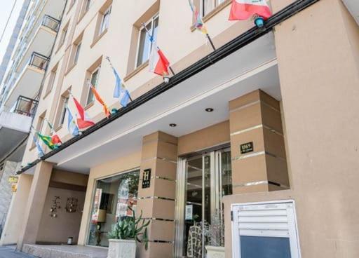 a building with flags on the front of it at Etoile in Mar del Plata
