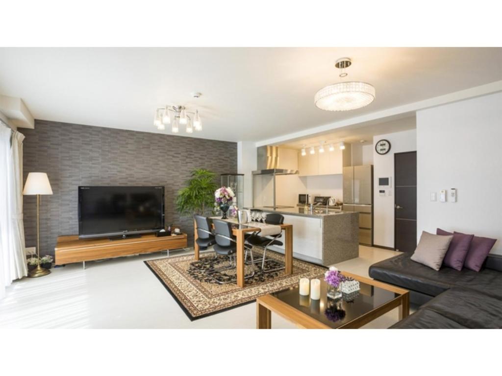 a living room with a couch and a table at Kyoto Four Sisters Residence - Vacation STAY 15185v in Kyoto