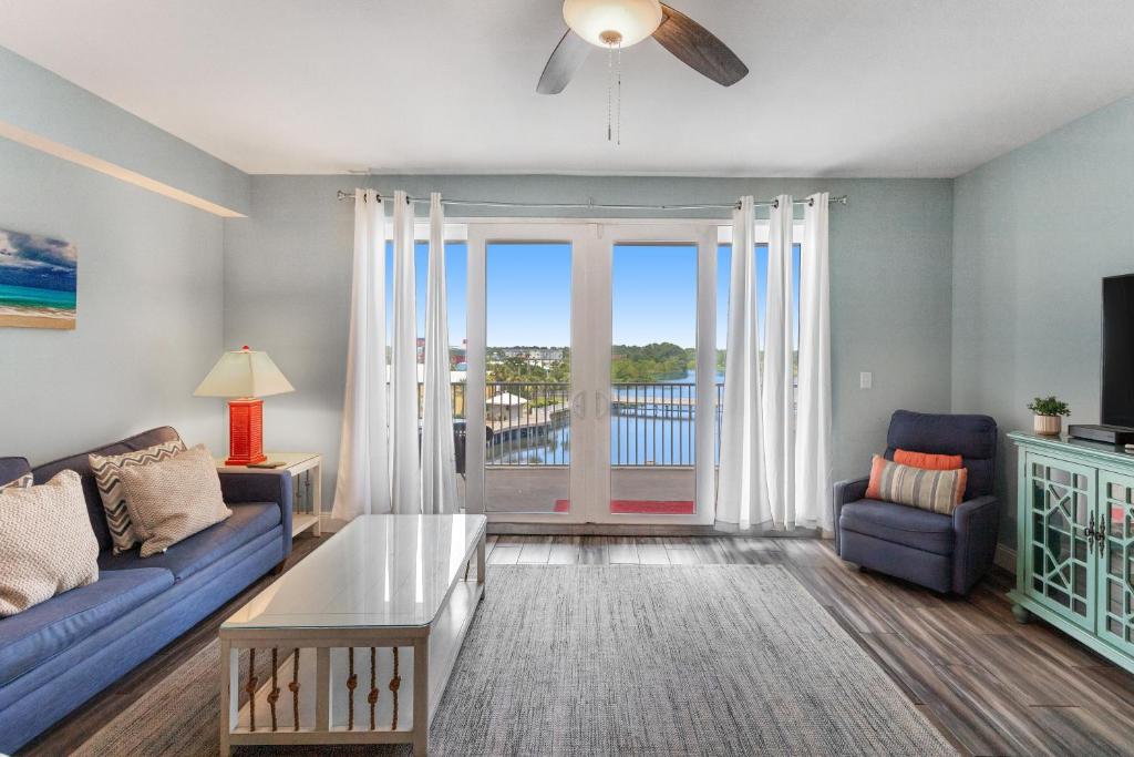 a living room with a blue couch and a table at Laketown Wharf 335! 1 BD, 2 Bathroom with Amazing Amenities in Panama City Beach