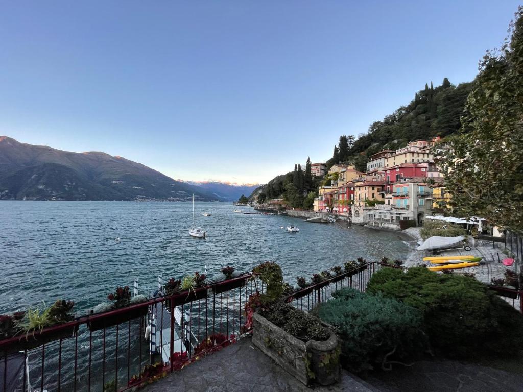 a body of water with buildings and boats on it at Varenna by Foot (no Taxi / Car needed) in Varenna