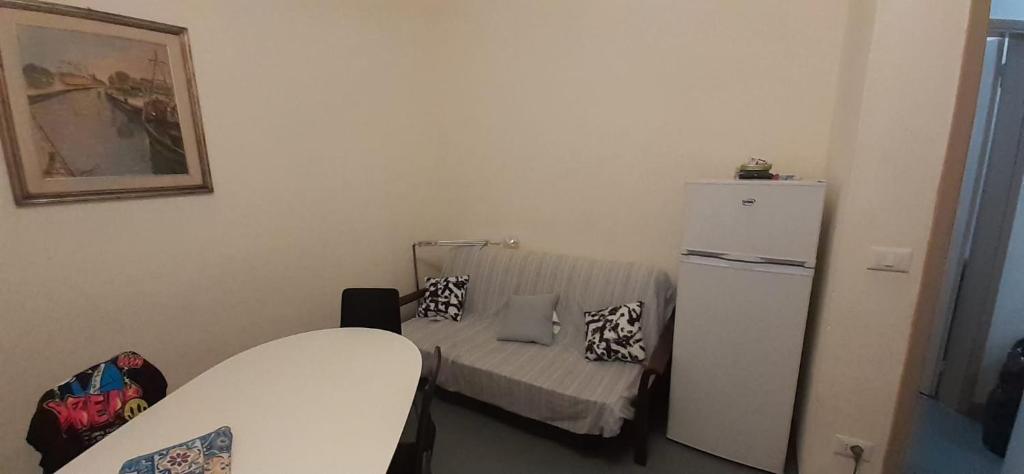 a small room with a small bed and a refrigerator at appartamento vale in Viareggio