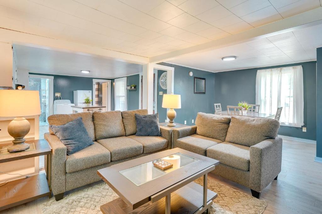 a living room with two couches and a table at Outdoorsy Oasis with Screened Porch in Claremont in Claremont