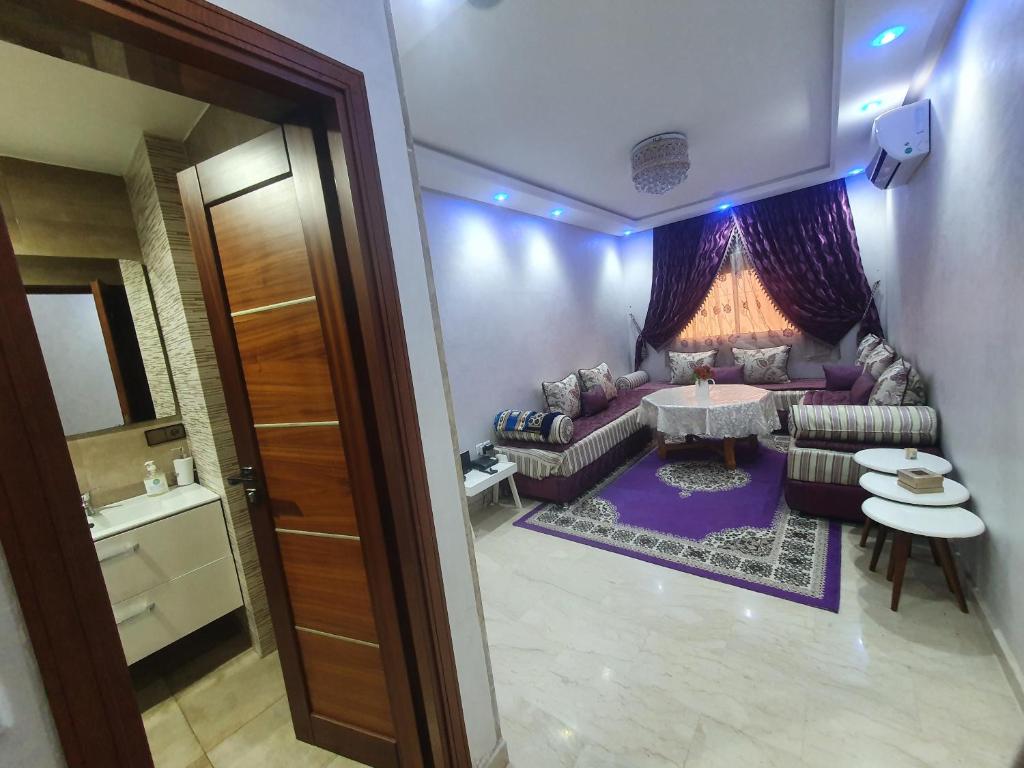 a living room with a couch and a table at Appartement darna à côté décathlon agadir 2chambre et salon in Agadir