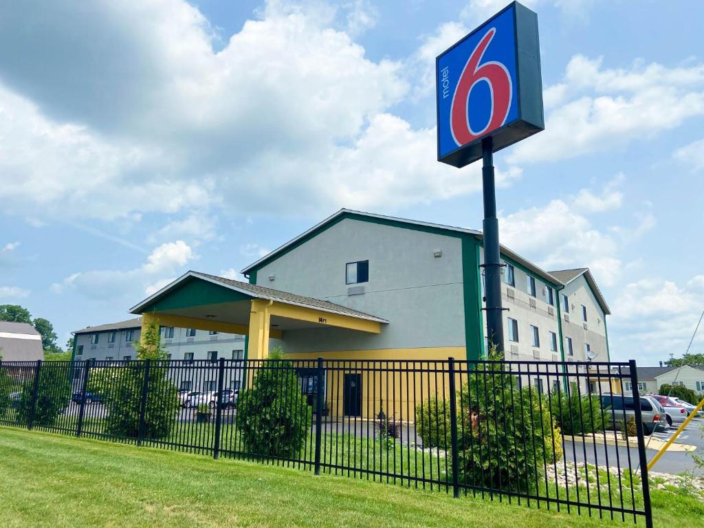 a gas station with a sign in front of a building at Motel 6 Lancaster in Lancaster