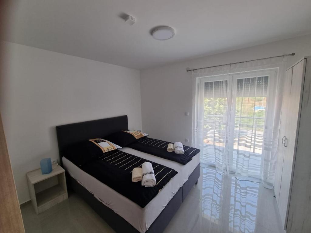 a bedroom with a bed with white shoes on it at Villa Ronić in Soko Banja