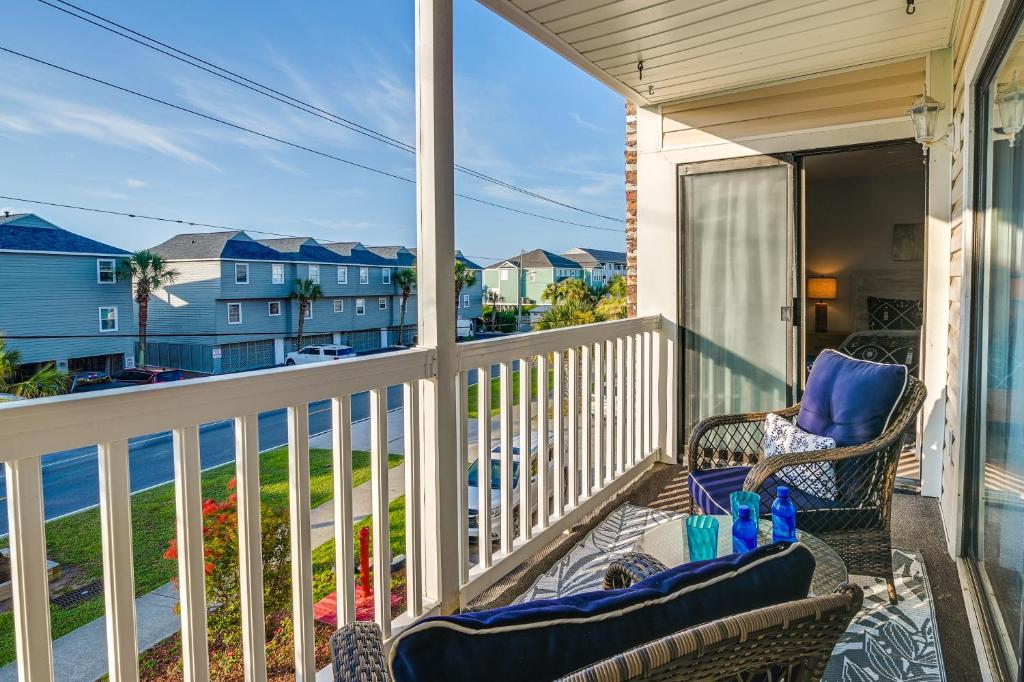 a balcony with a chair and a view of the ocean at Surfside Beach Condo with Ocean Access and Balcony! in Myrtle Beach