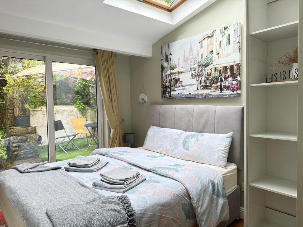 a bedroom with a bed with towels on it at Centre of Killaloe Village, Lovely Apartment in Killaloe